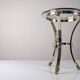Neoclassical side table in brass and bevelled glass with ram's heads, 1970s.