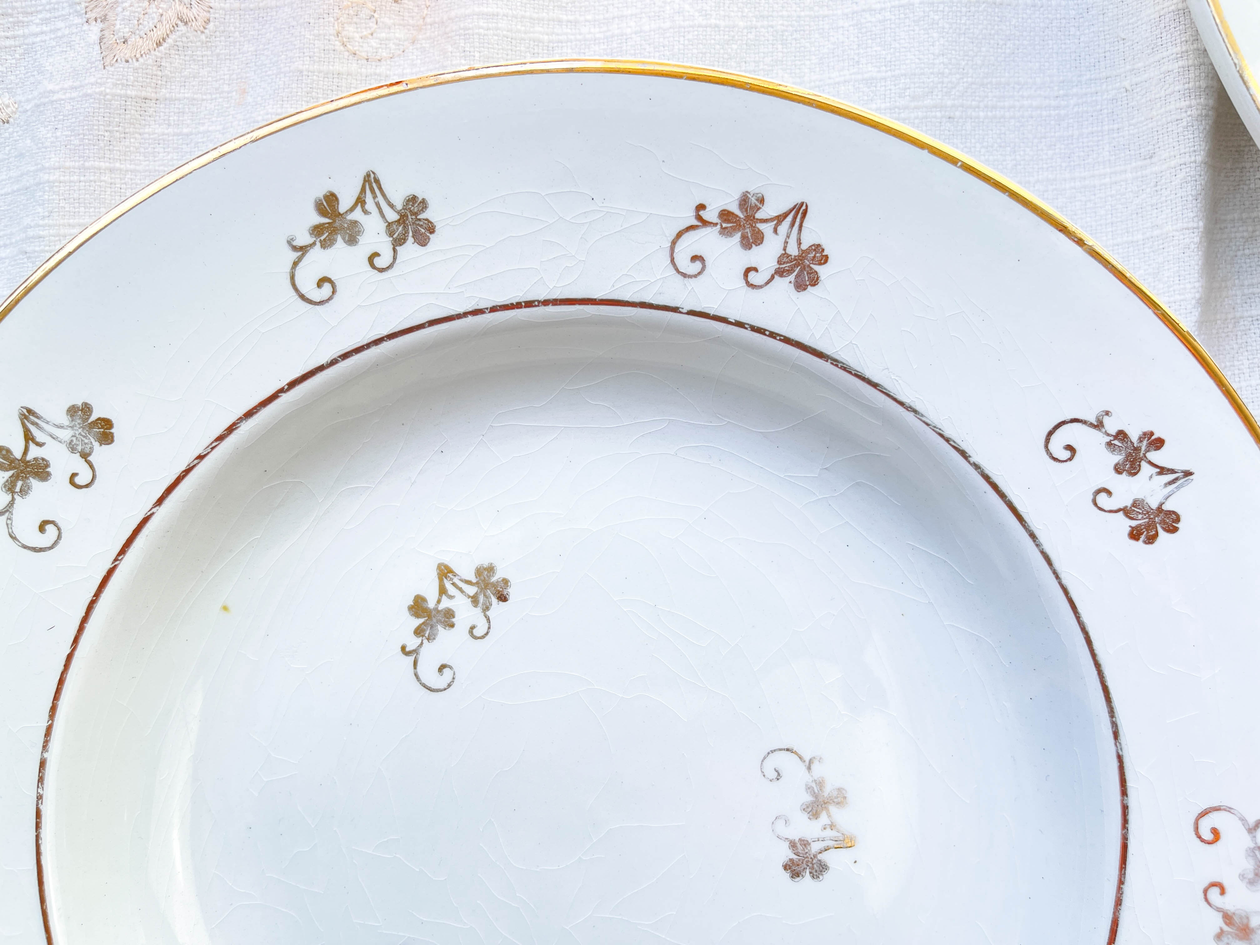 4 white porcelain L'Amandinoise soup plates with gold floral pattern