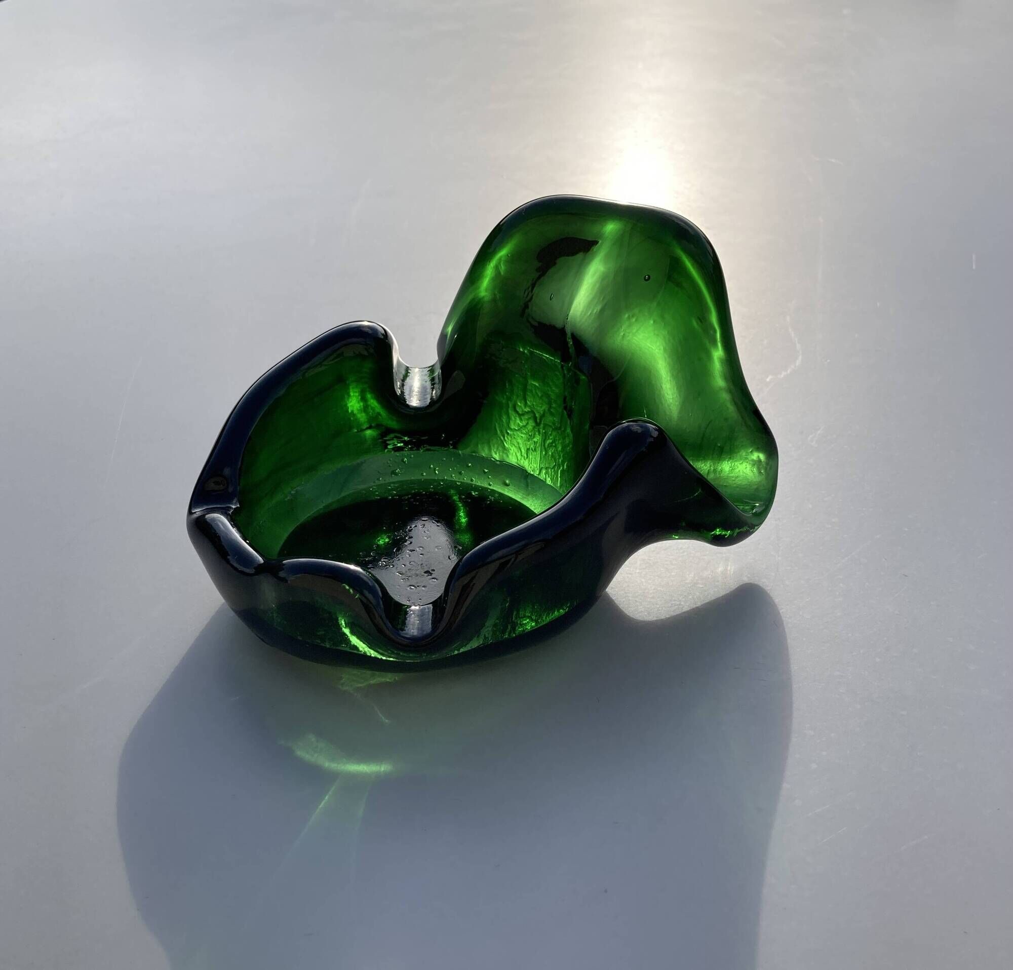 Sculptural ashtray in emerald green glass