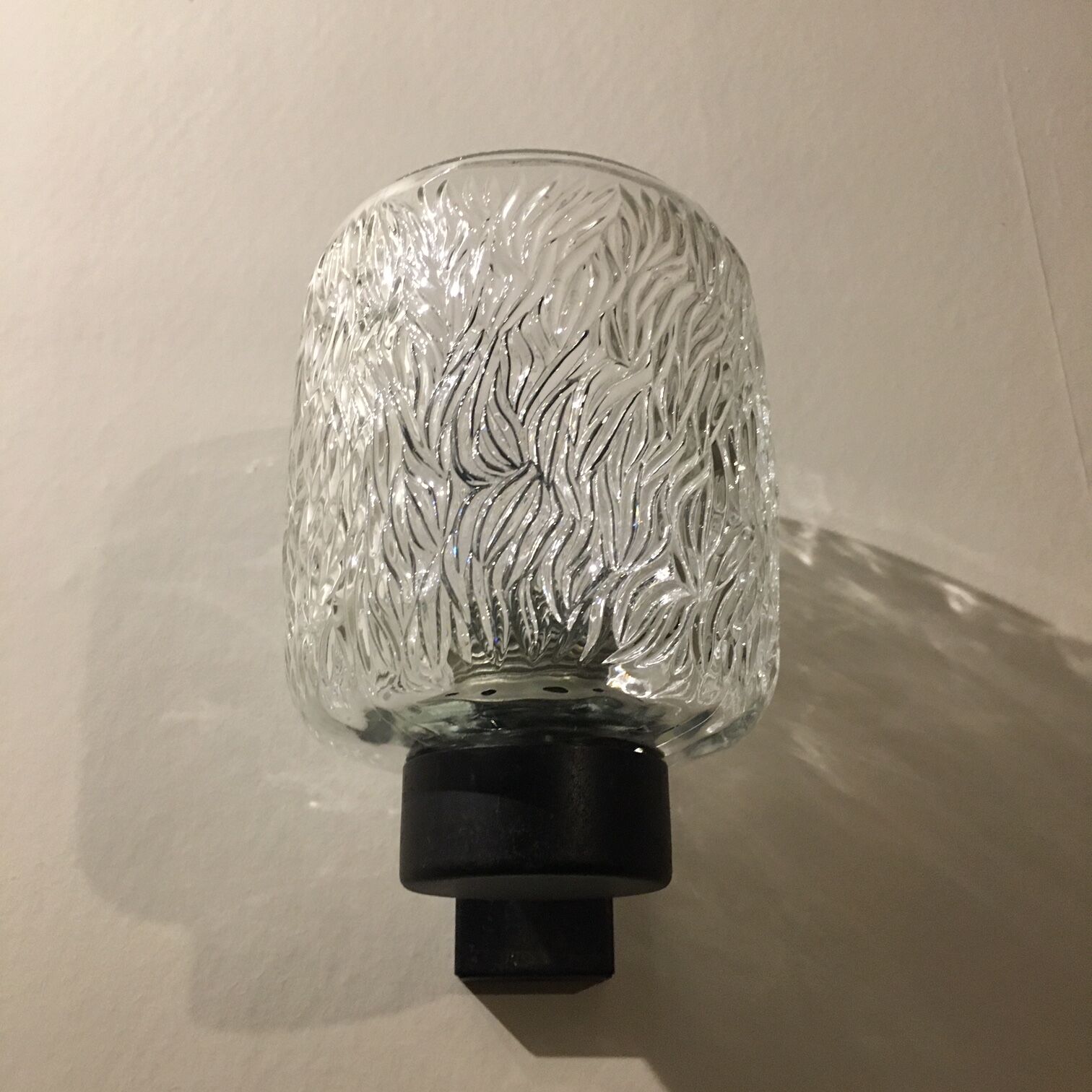 Black metal and molded glass wall sconce