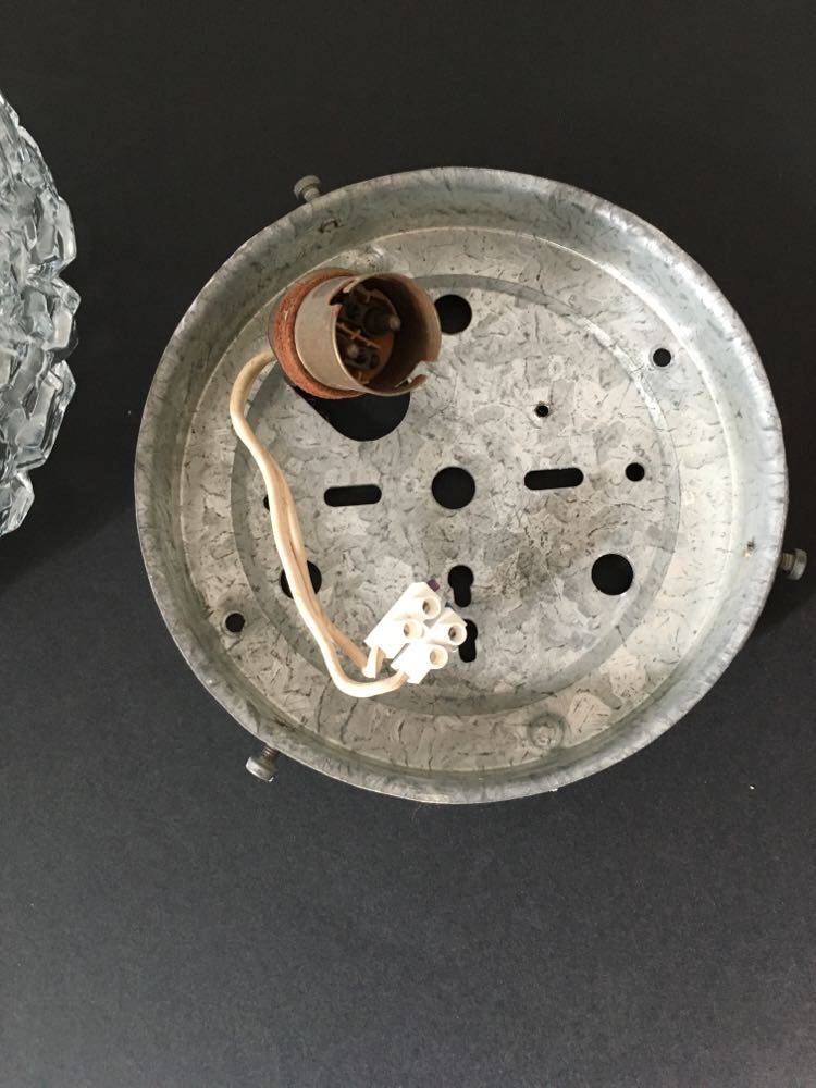 Round ceiling or wall lamp in worked glass. Gray metal support