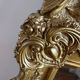Large antique baroque mirror with angel decorations.