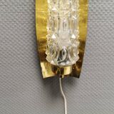 Older wall lamp in brass with hard pressed glass shade.
