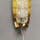 Older wall lamp in brass with hard pressed glass shade.