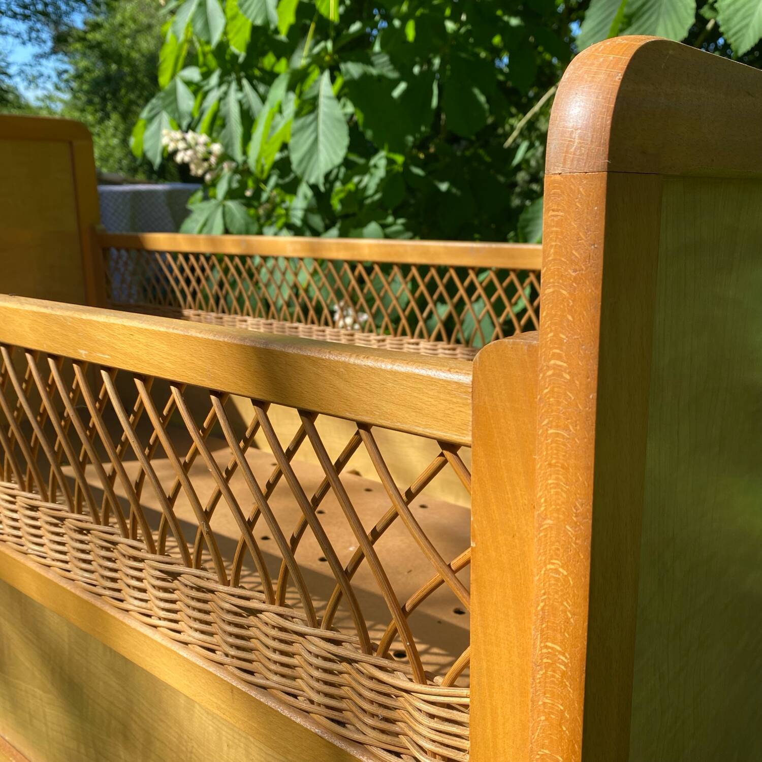 Vintage wooden and rattan baby cot from the 1960s.