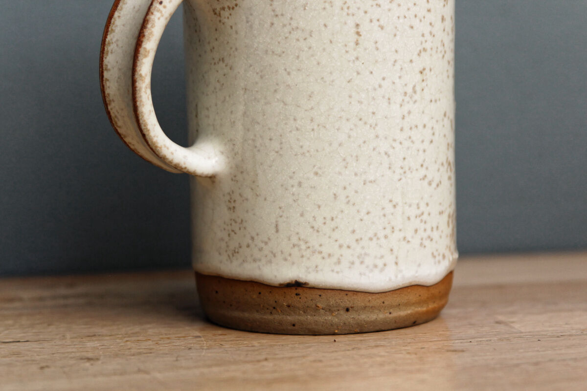 Enamelled sandstone milk jar, signed