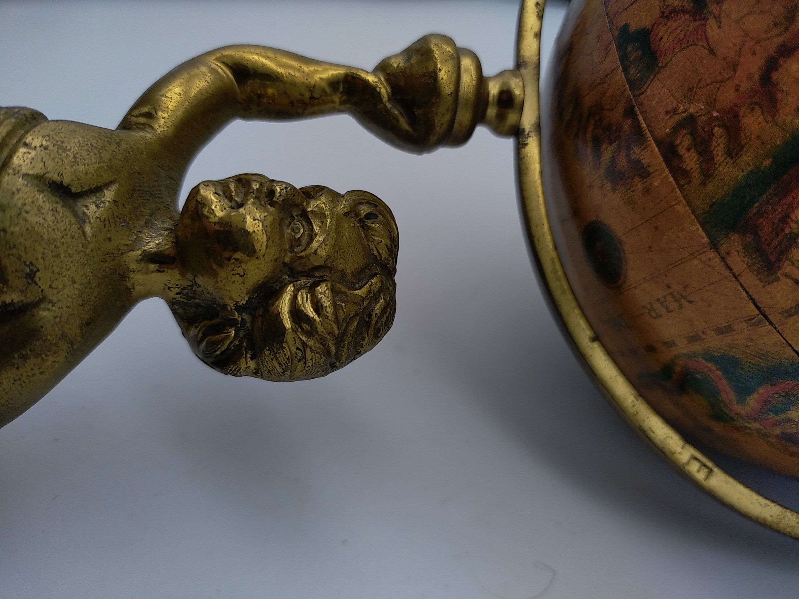 Cherub or putti carrying a globe