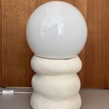 Large table lamp in off-white ceramic with an organic globe shape.