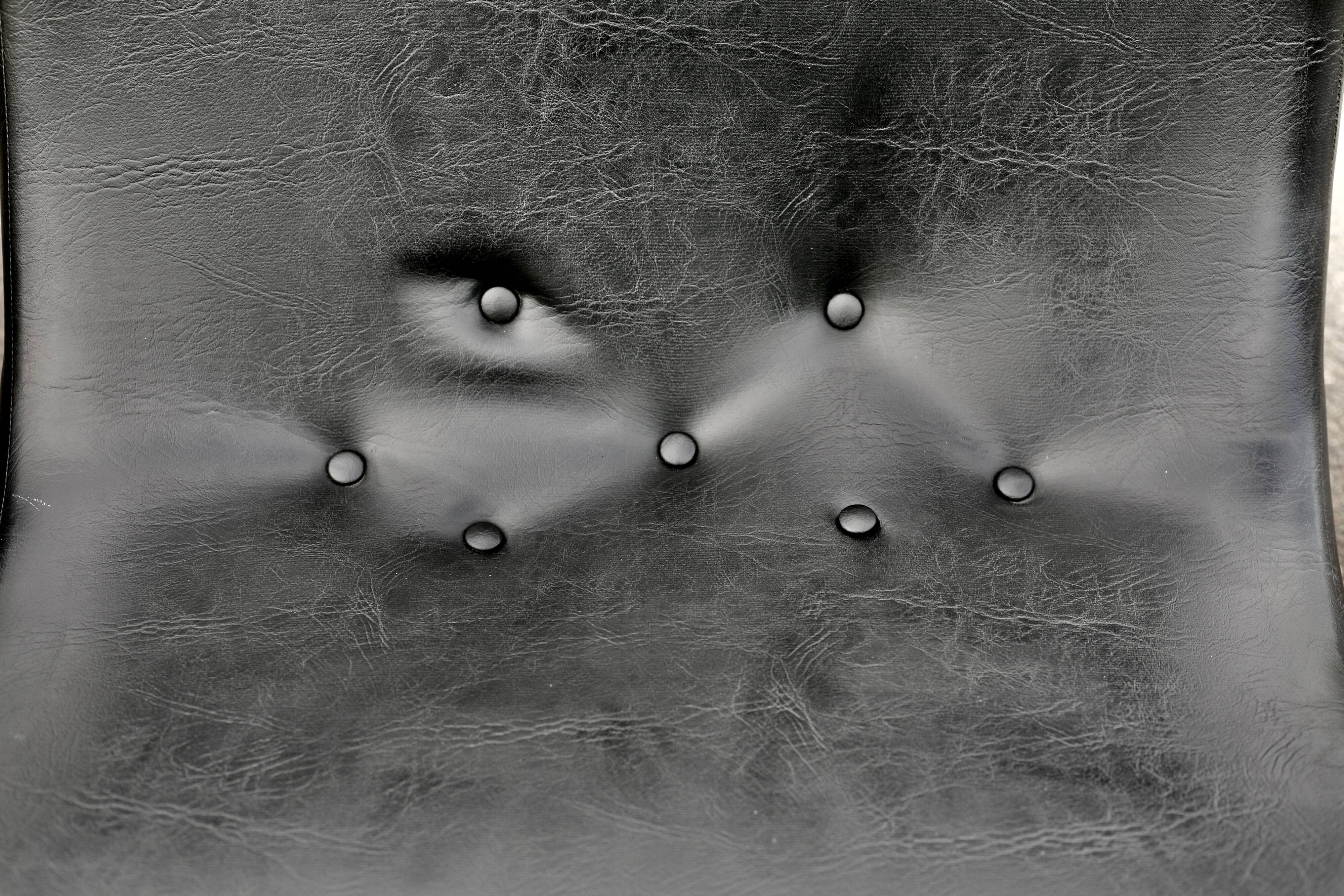 Pair of “space age” low chairs. Black faux leather. Circa 1970