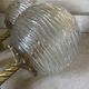Pair of neoclassical wall sconces in twisted brass and ribbed glass.