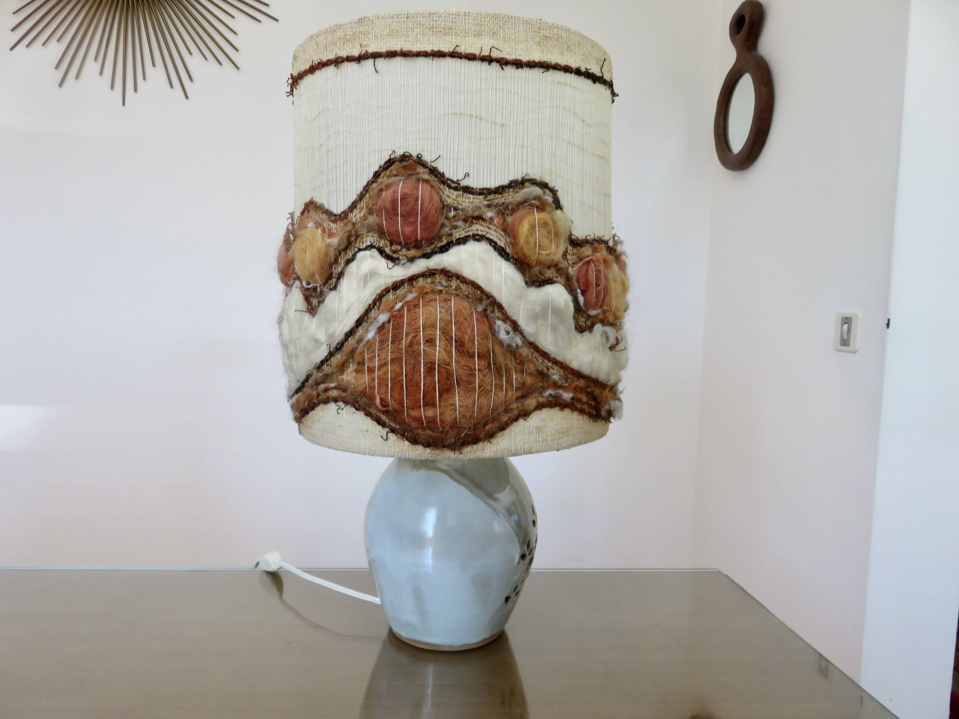 Ceramic lamp with double lighting and openwork design.