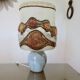 Ceramic lamp with double lighting and openwork design.