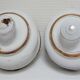 Four white enamelled metal cheese bells early twentieth century