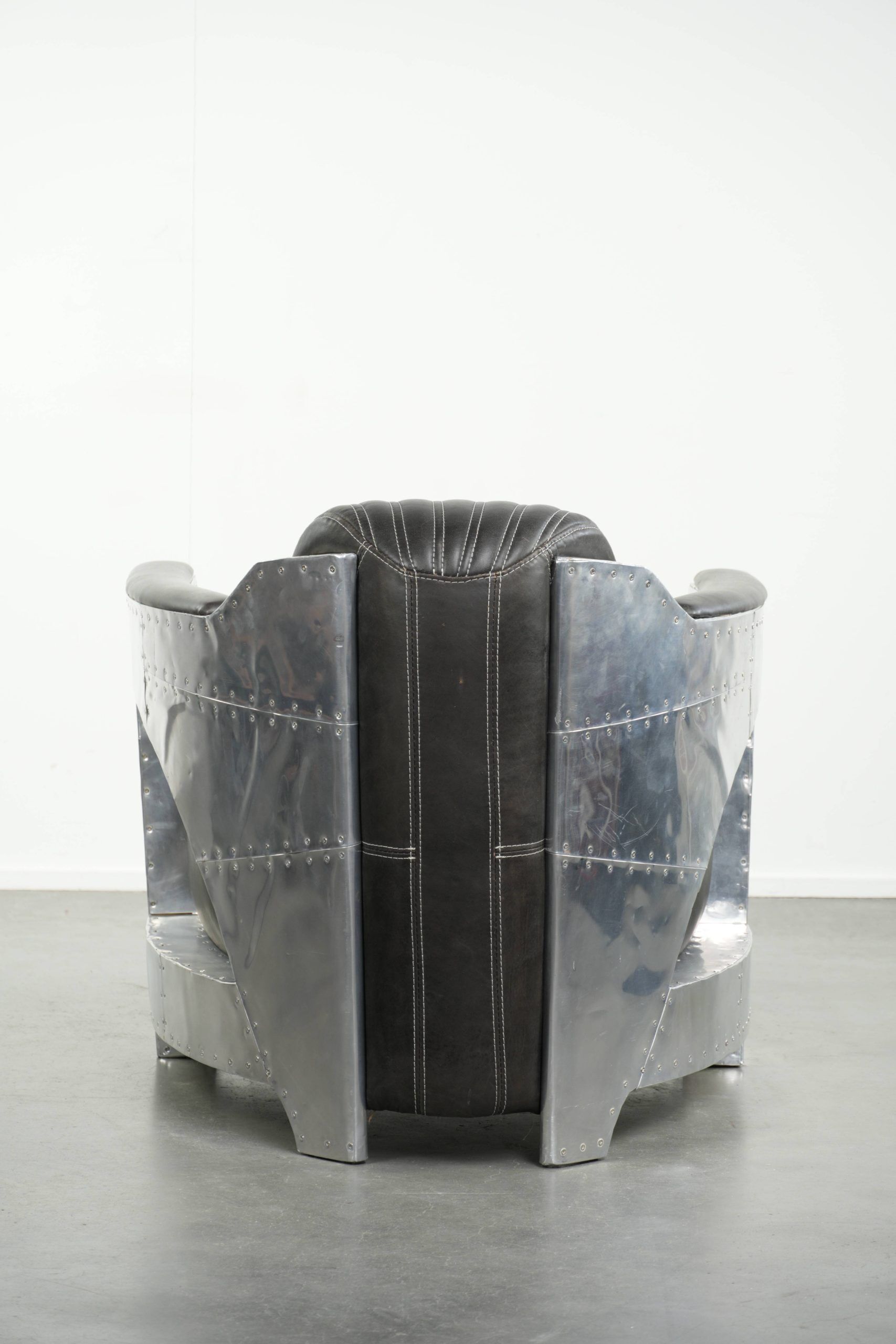 Cow leather aviator design armchair finished with aluminium and rivets