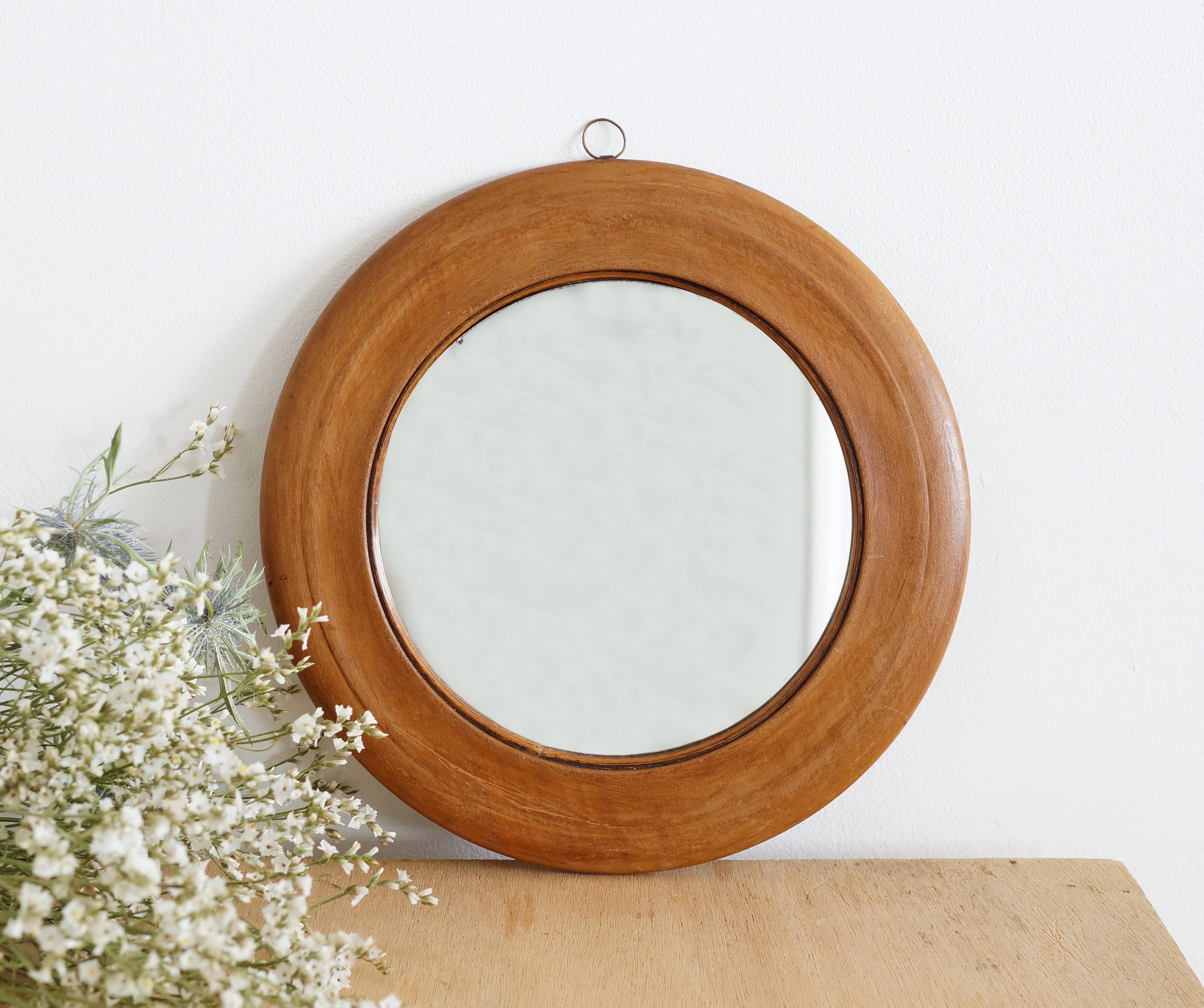 Antique round mirror with turned wooden frame