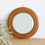 Antique round mirror with turned wooden frame