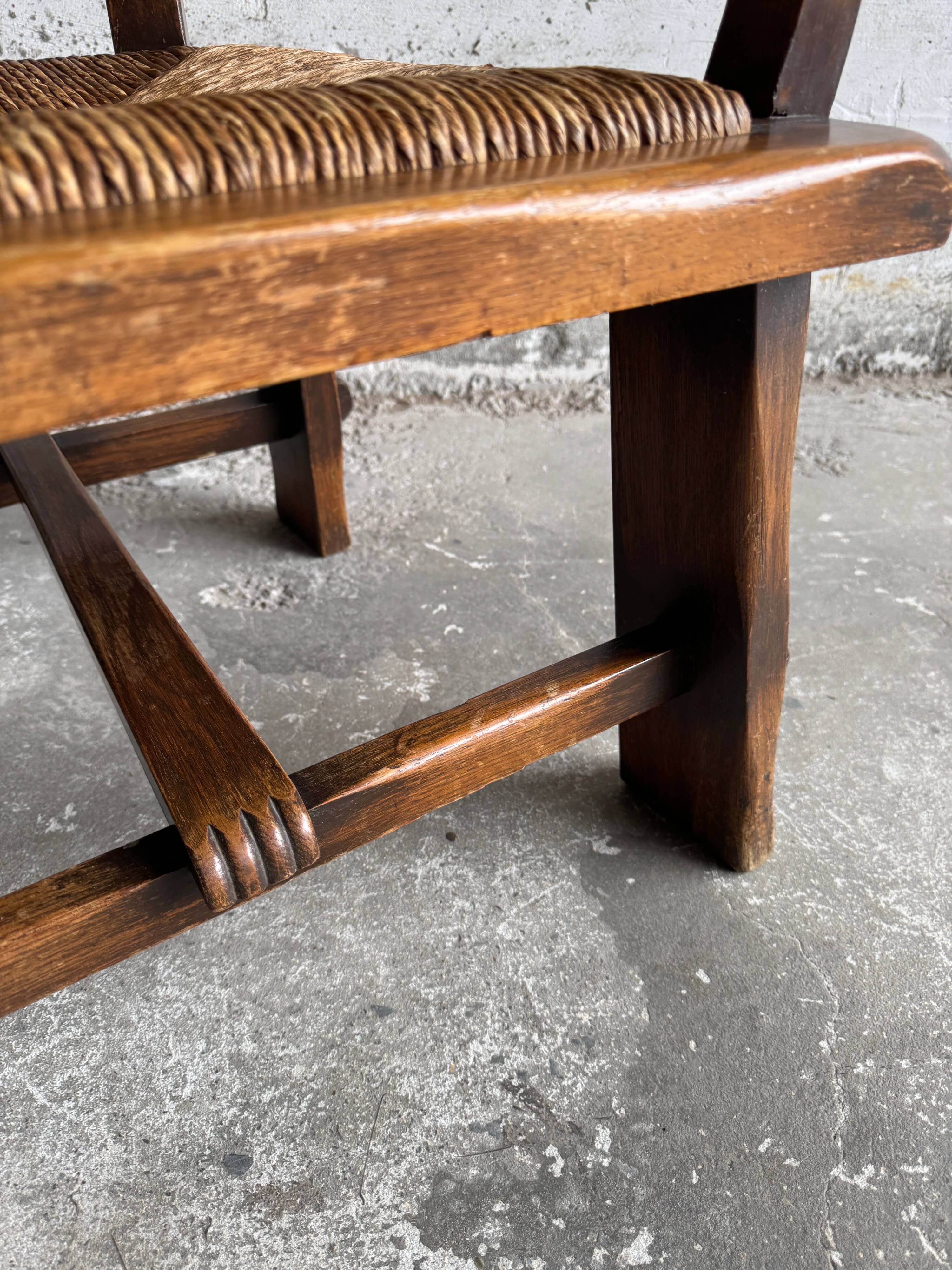 Brutalist dark brown solid wood armchair with natural rattan seat and cognac leather back