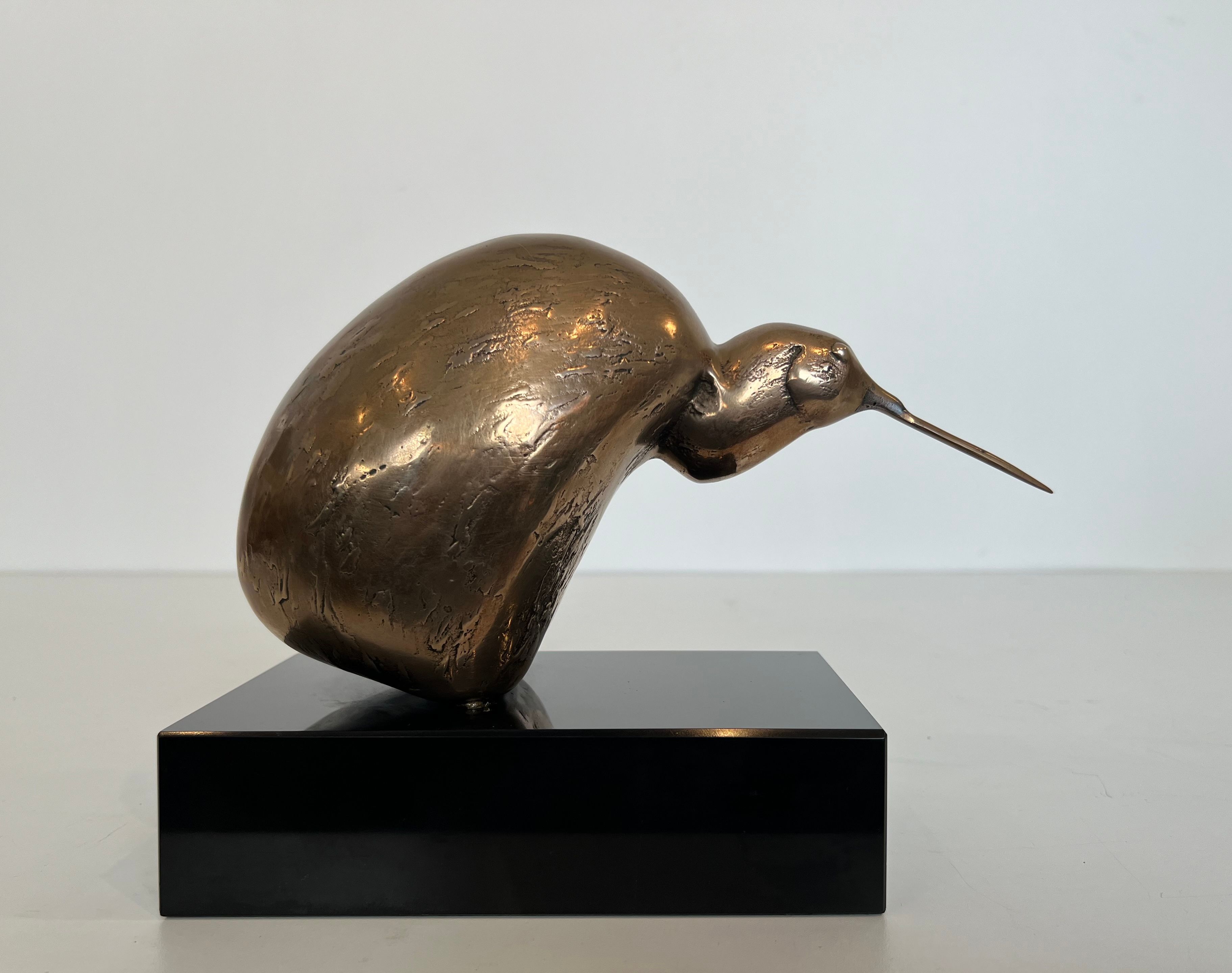 Bronze sculpture representing a stylised bird on a black marble base, signed and numbered.