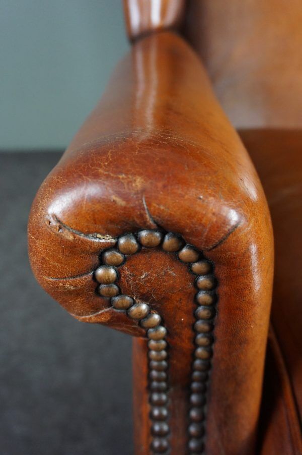 Eared armchair in patinated sheepskin