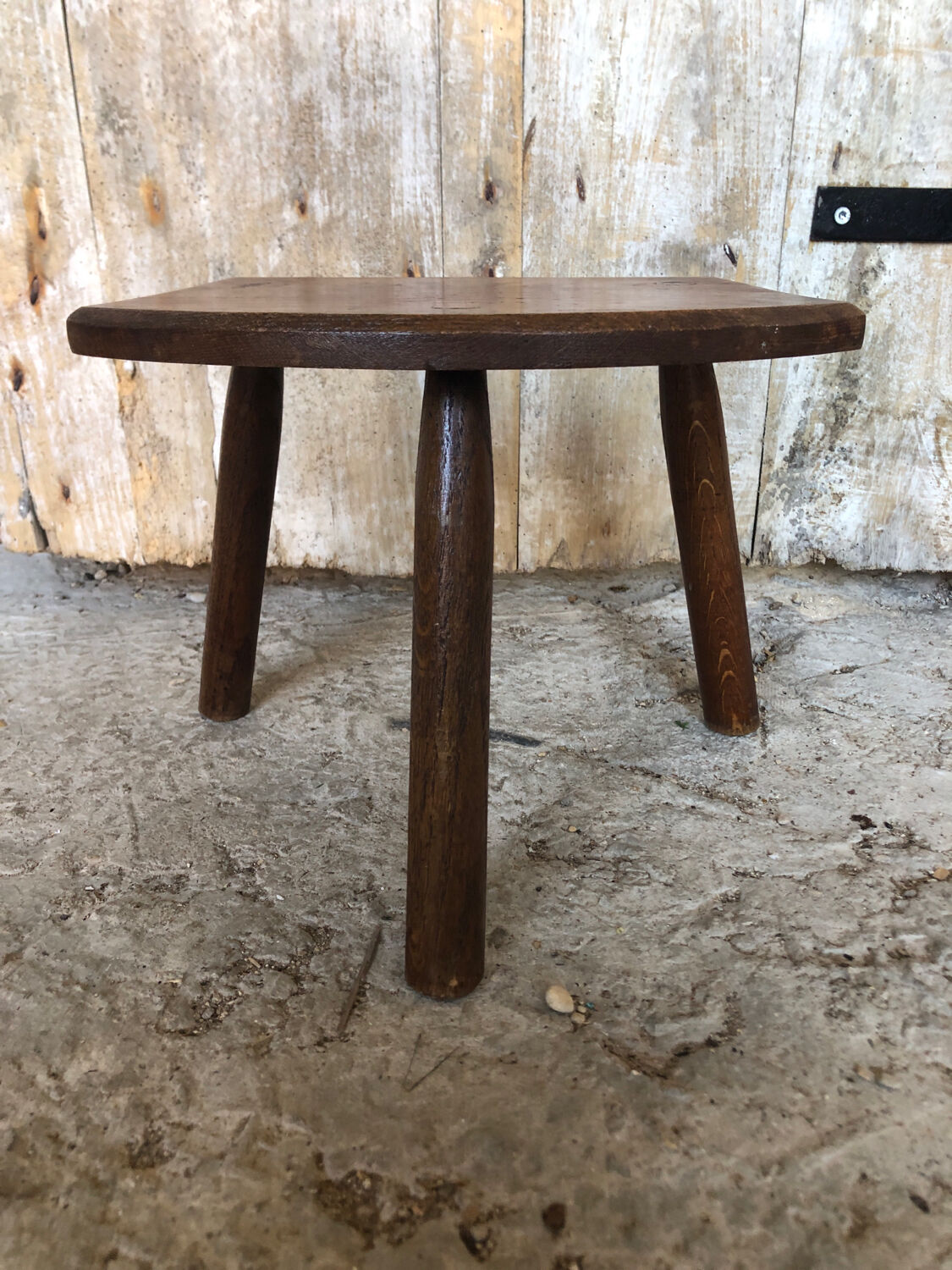 Old vintage wooden tripod milking stool