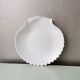 White ceramic dish shaped like 80s shells