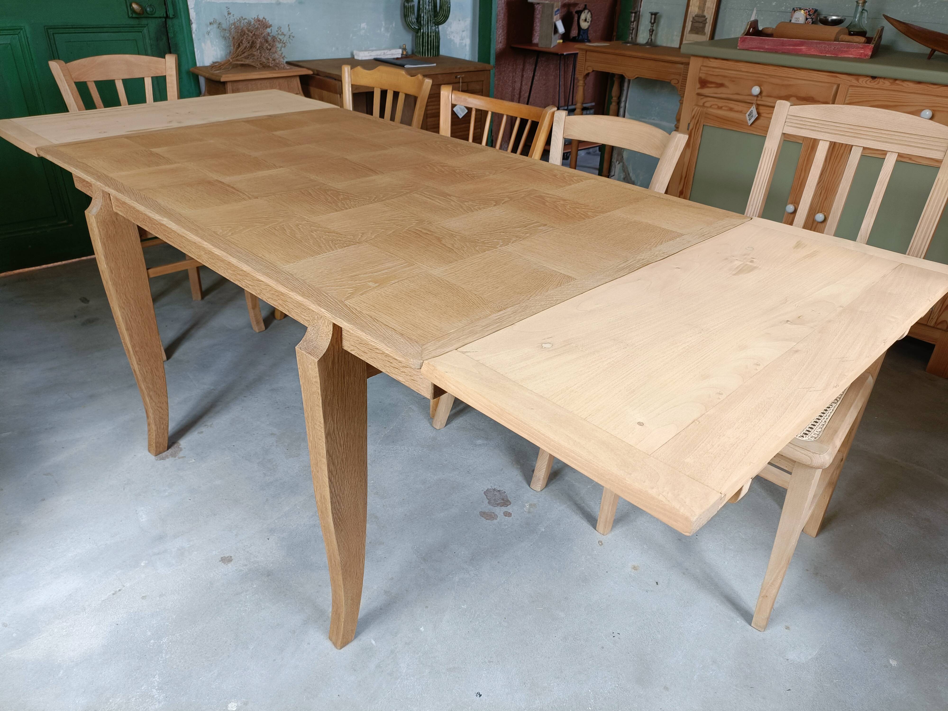Oak dining table with a checkerboard top and extensions.