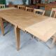 Oak dining table with a checkerboard top and extensions.