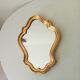 Baroque mirror in gilded wood from the 1960s.