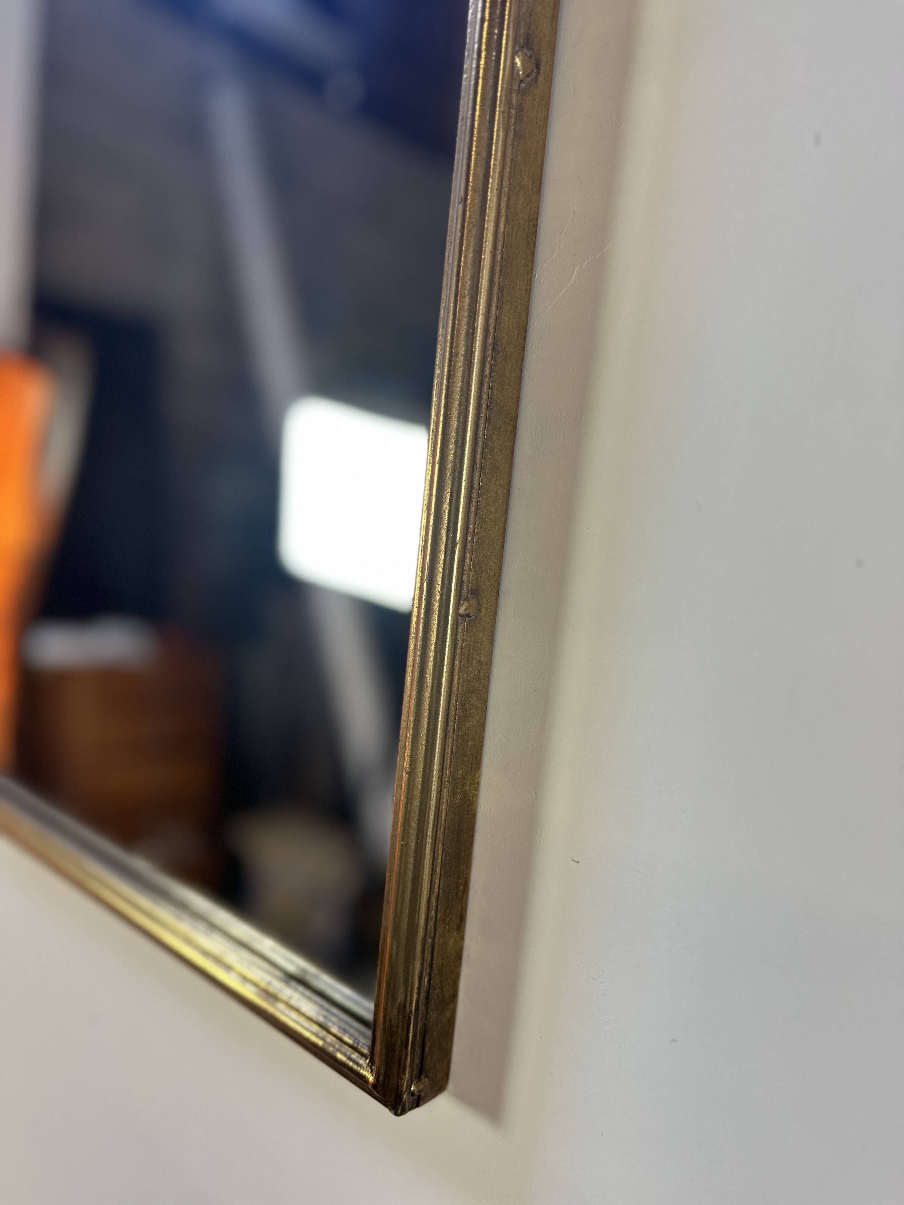 Golden metal pediment mirror from the 2000s.