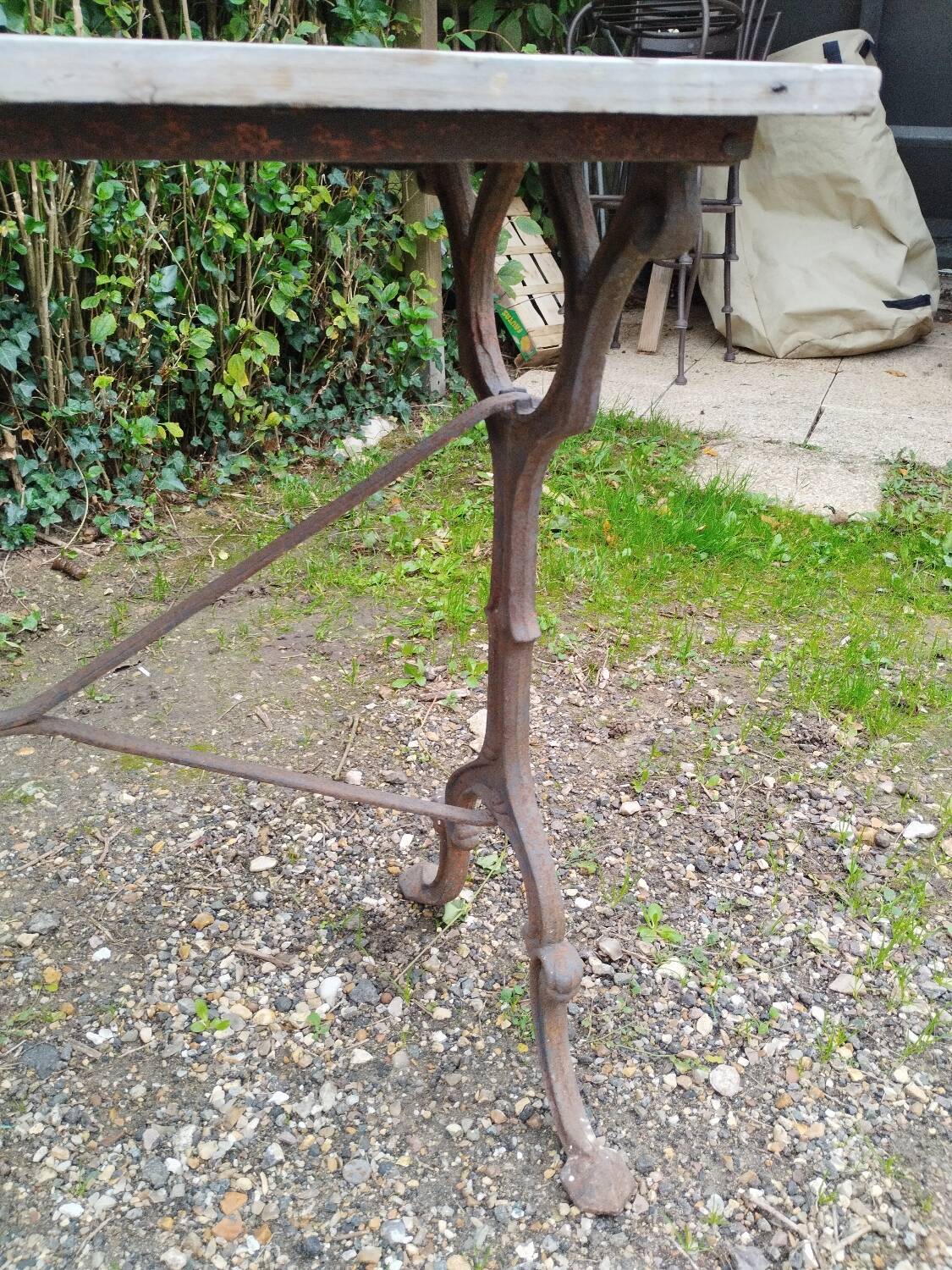 Antique bistro table with iron legs and wooden top