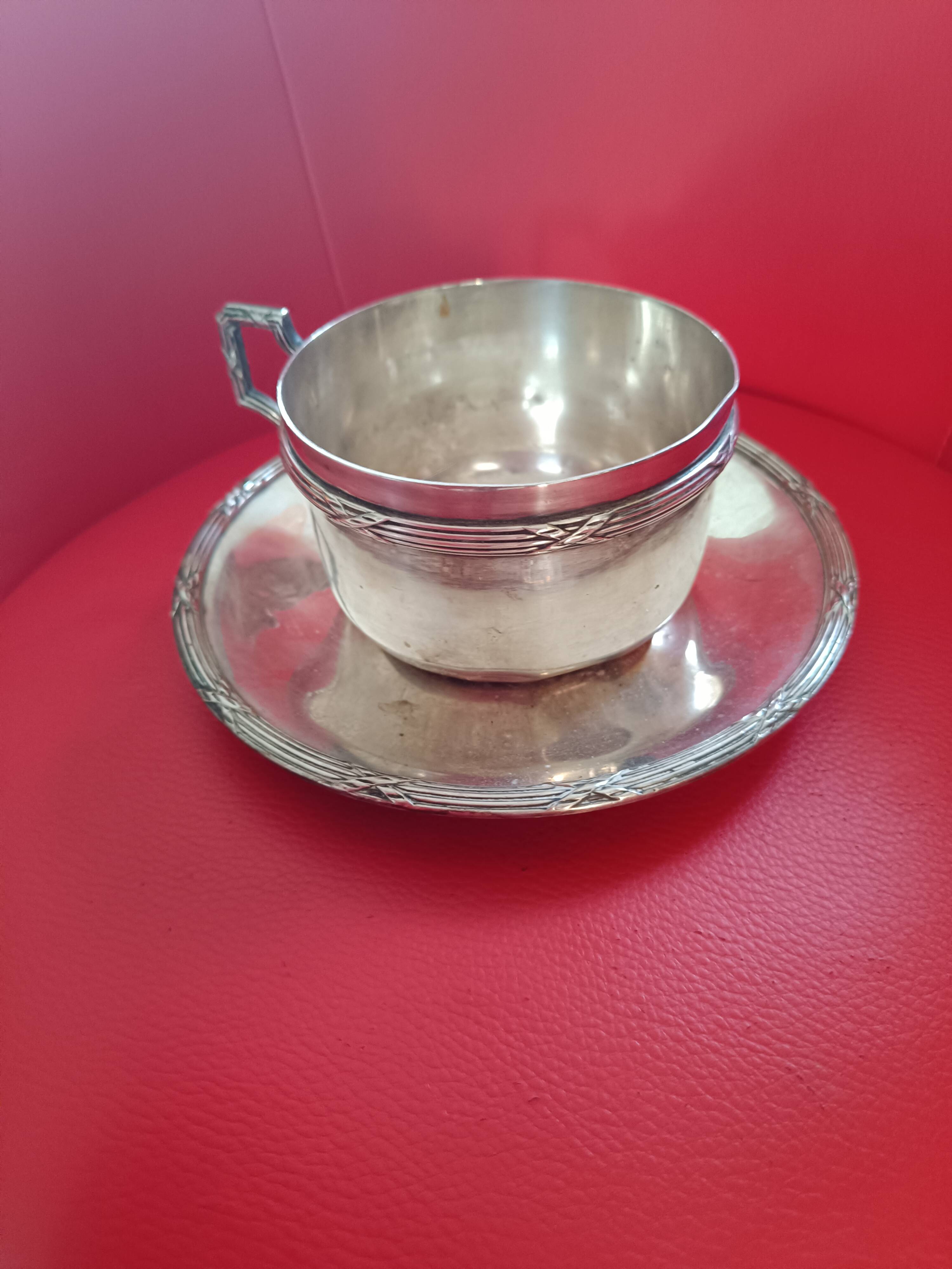 Silver-plated cup and saucer.