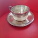 Silver-plated cup and saucer.