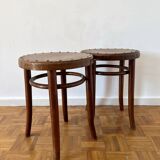 2 antique bistro stools with curved wood and caning effect.