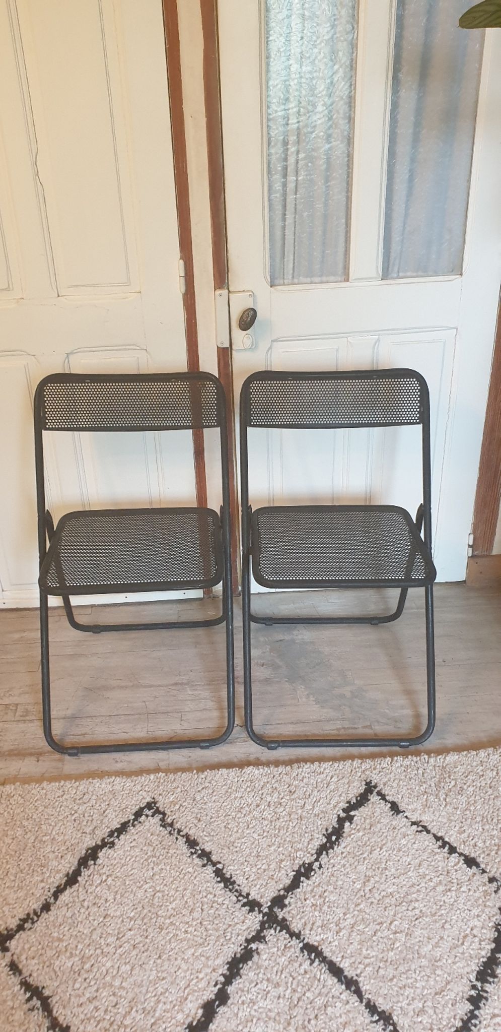 Pair of folding chairs in perforated metal
