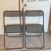 Pair of folding chairs in perforated metal