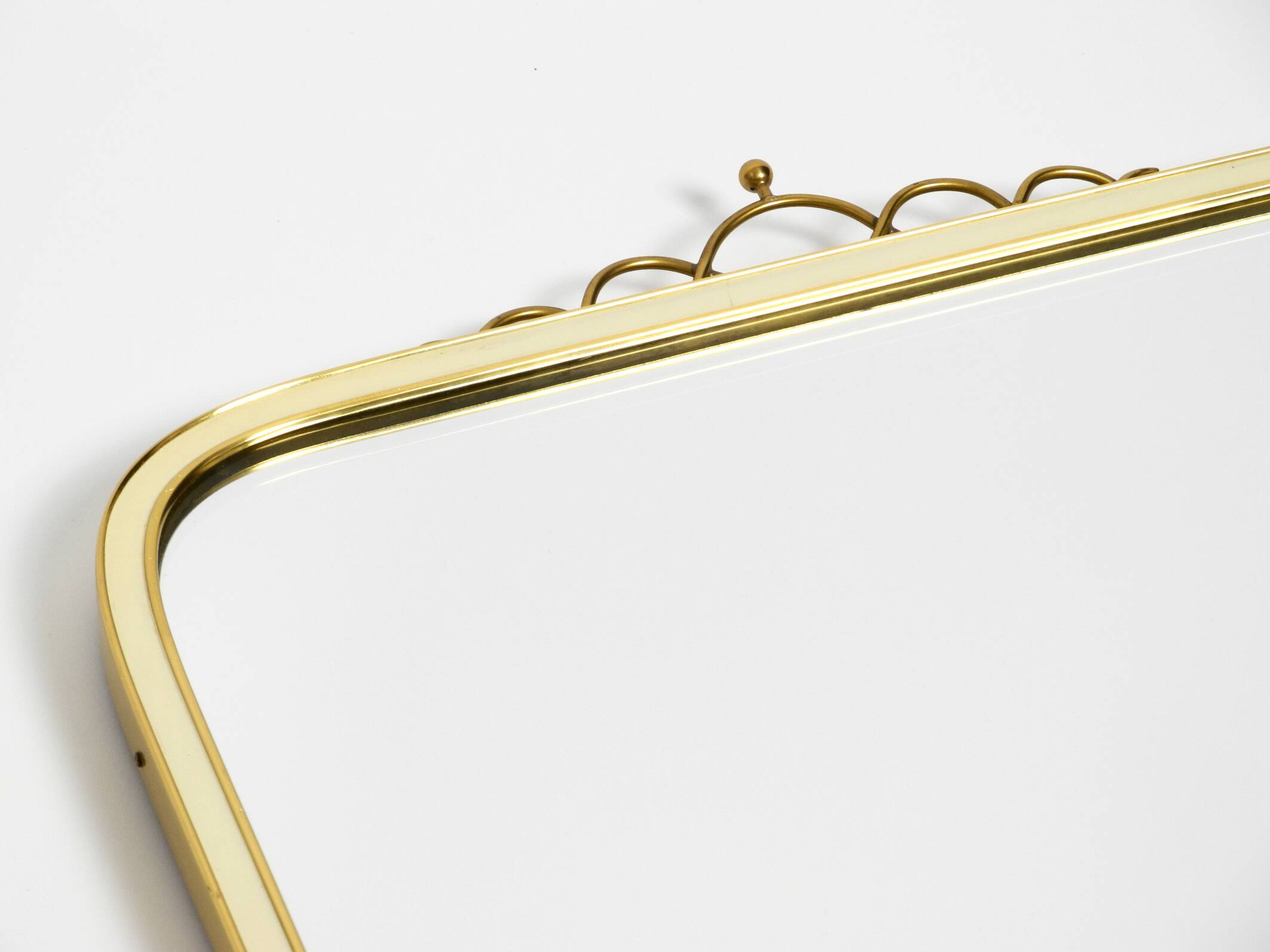Large heavy long Mid Century brass wall mirror by Münchner Zierspiegel