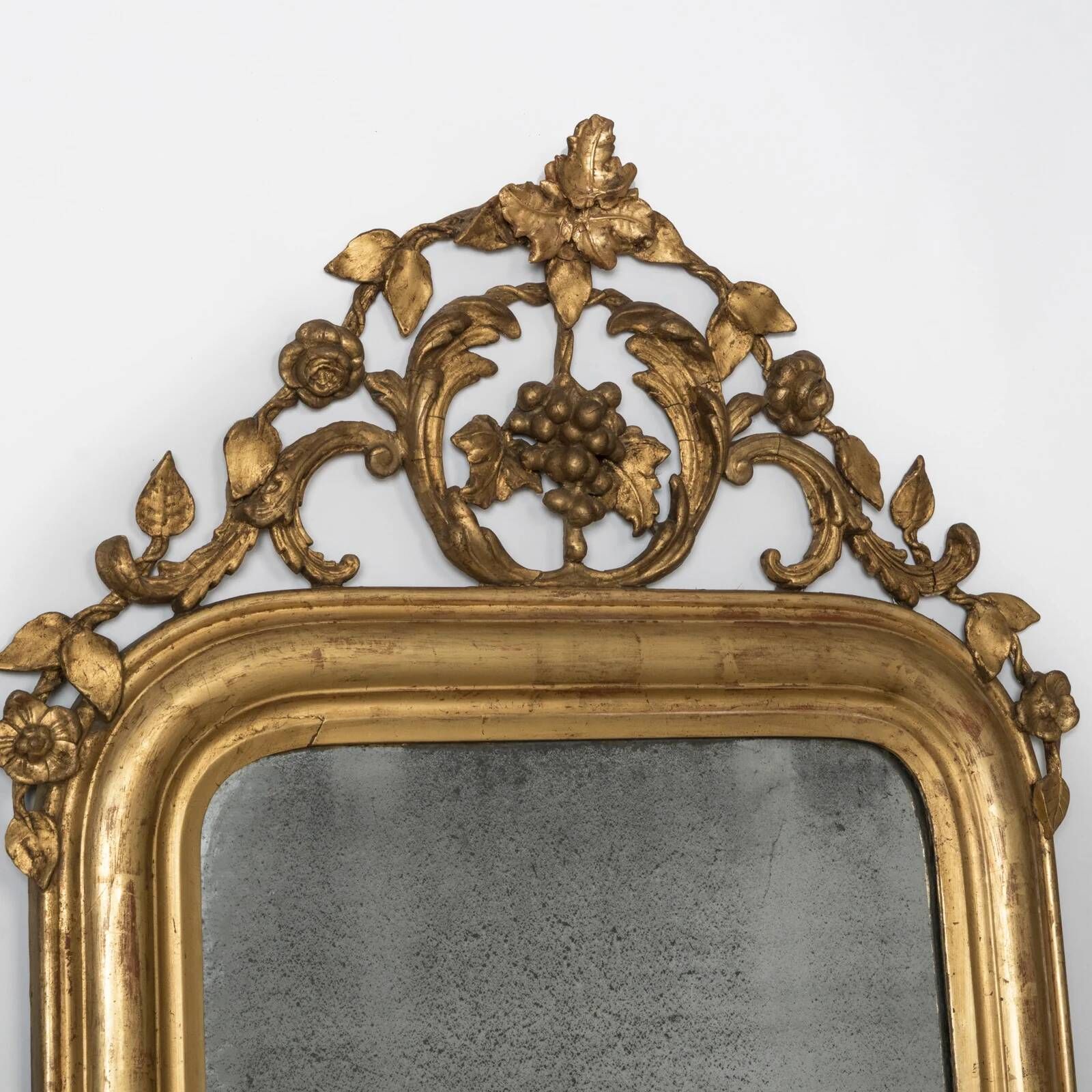 Louis-Philippe mirror from the 19th century with foliage and grape cluster motifs.