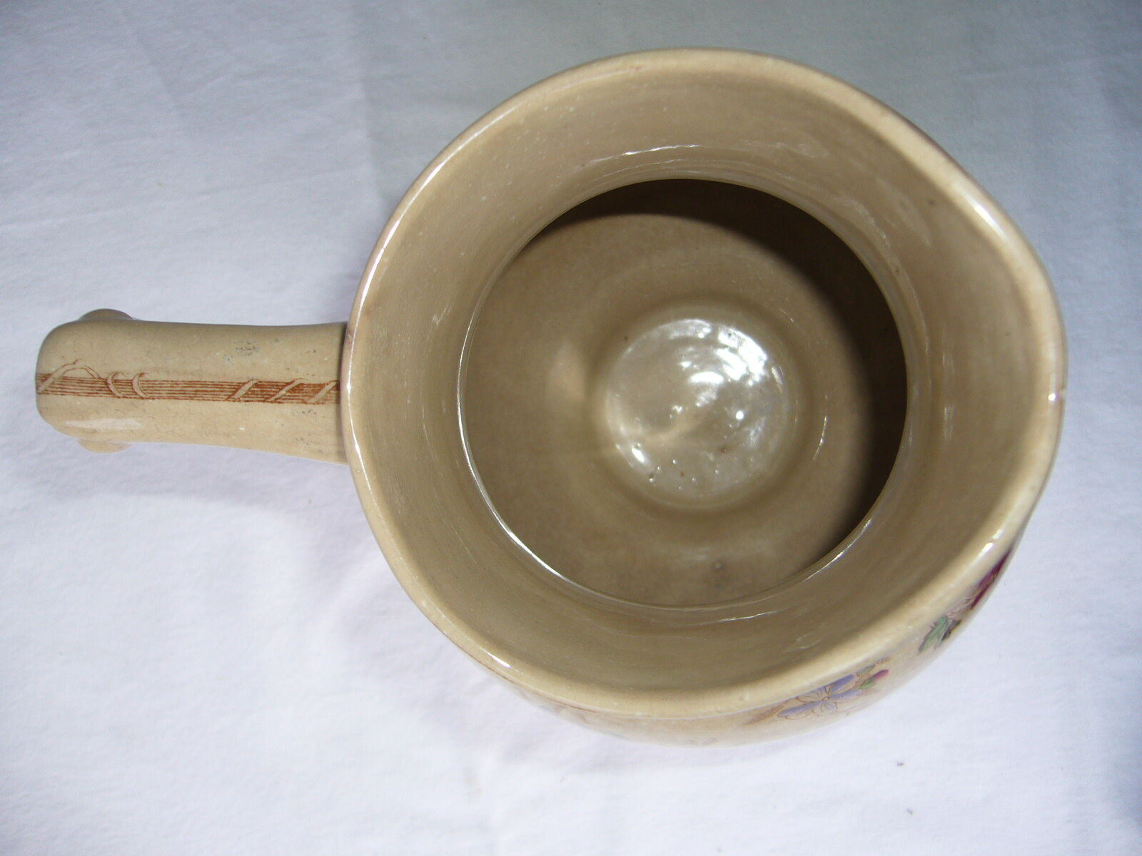 Antique pitcher decorated with flowers