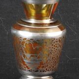 Old small glass vase decorated with silver