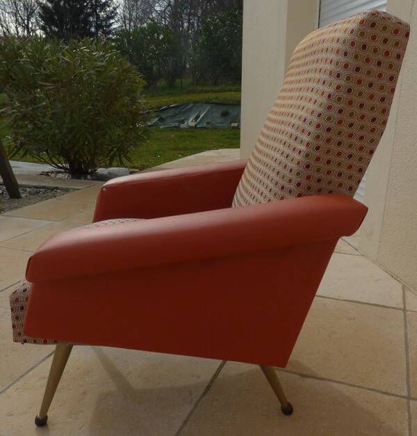 Vintage rockabilly retro armchair in orange faux leather and fabric.