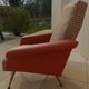 Vintage rockabilly retro armchair in orange faux leather and fabric.