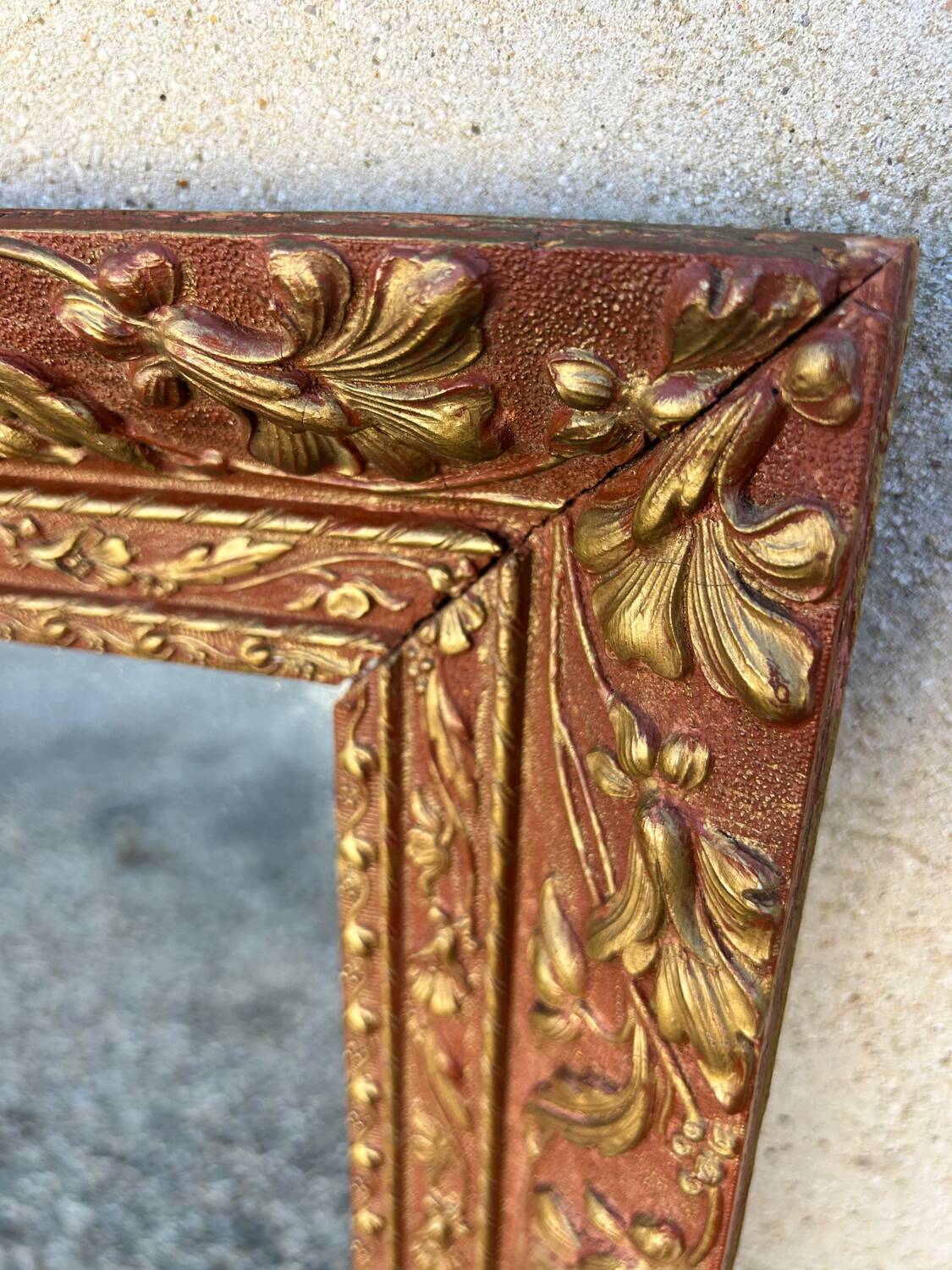 Antique mirror in patinated gilt wood