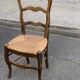 Solid oak carved chair with rush seating, Louis XV style, 19th century.