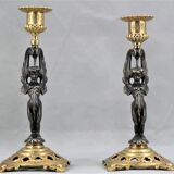 Pair of candle holders in gilded bronze and patinated with a candle