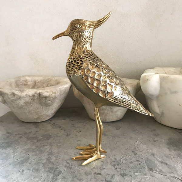 Crested bird in golden brass