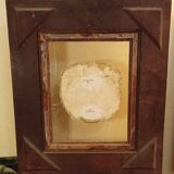 Antique gilded frame with stone lion head ornament on plexiglass