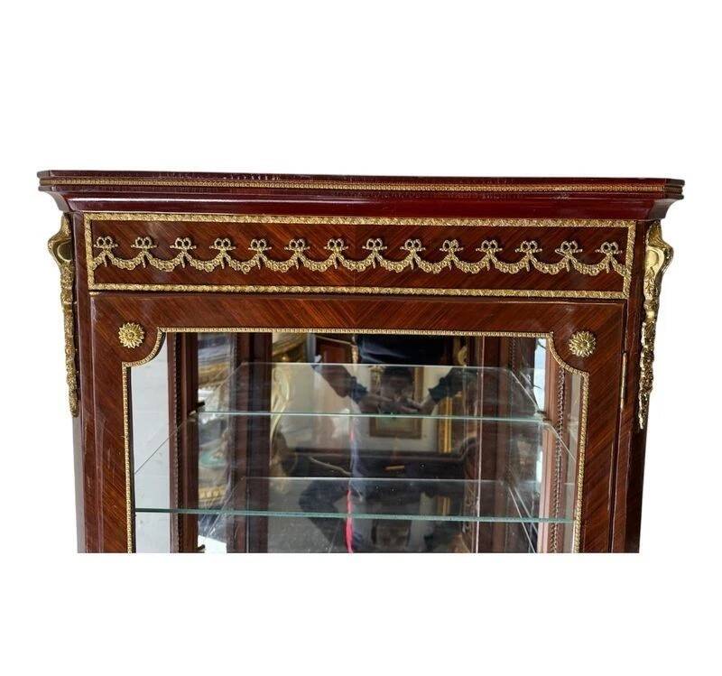 Louis XV style display cabinet in wood and bronze, with several shelves