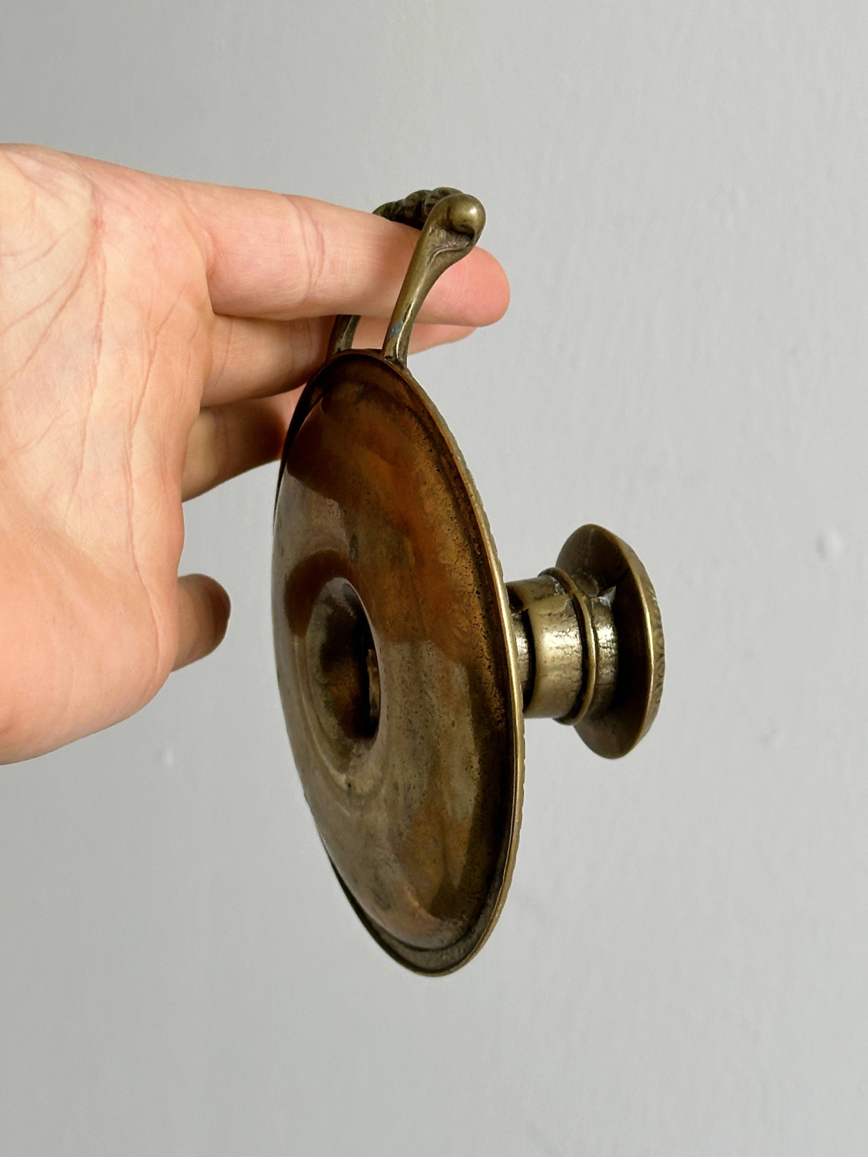 Brass candle holder with handle.