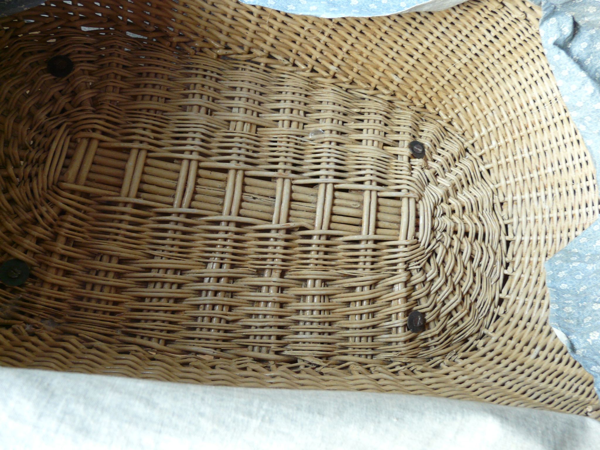 Old wooden cradle and wicker on wheels