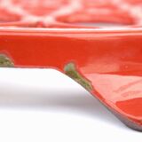 Vintage red enameled cast iron trivet